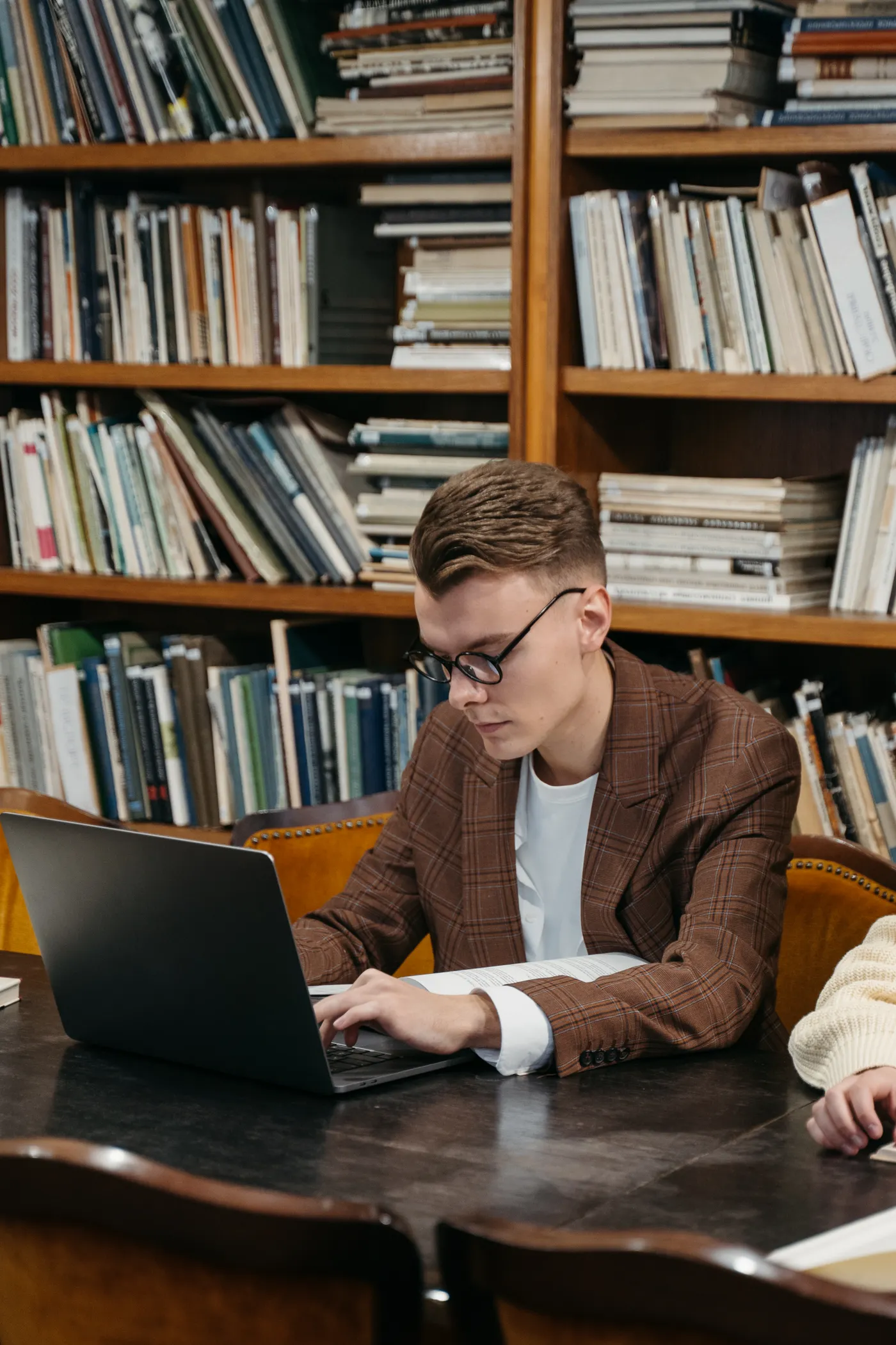 Person using a computer in a public library as a low-cost technology option