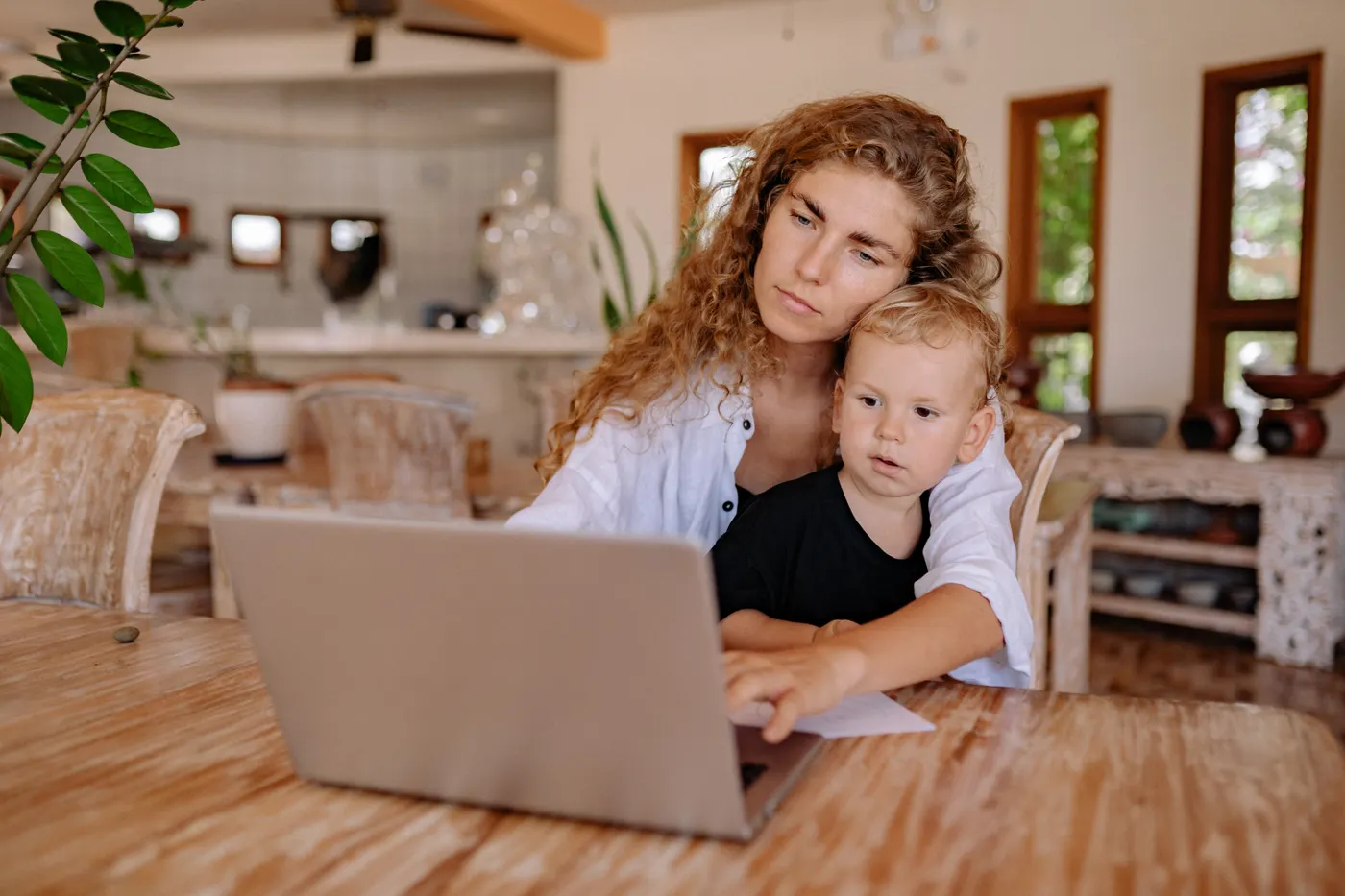 Parent and child using a computer together at home